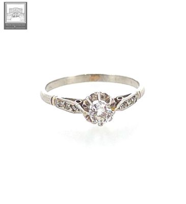a close up of a diamond ring on a white background