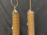 a pair of antique brass bird feeders with birds on them