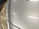 a close up of the hood of a white car