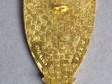 a close up of a gold medal on a white surface