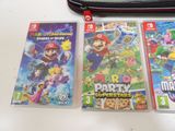 three nintendo wii games sitting on top of a table next to a laptop
