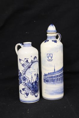two blue and white vases sitting next to each other on a black background