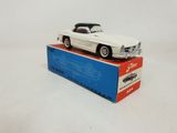 the toy car is sitting on top of the box on the table