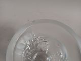 a glass bowl that has a small object inside of it