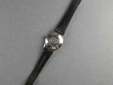 an image of a watch laying on top of a table