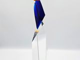 a glass sculpture of a pencil sticking out of a piece of paper