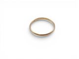 a close up of a gold ring on a white surface