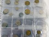 a lot of coins in a plastic box on a table