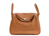 a brown leather shoulder bag with a metal clasp