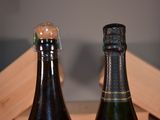two bottles of wine sitting next to each other on a table
