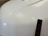 a measuring tape on the top of a white car