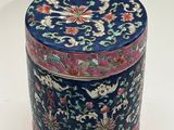 a blue and red box with a floral design on it