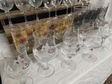 many wine glasses sitting on a table with a white table cloth