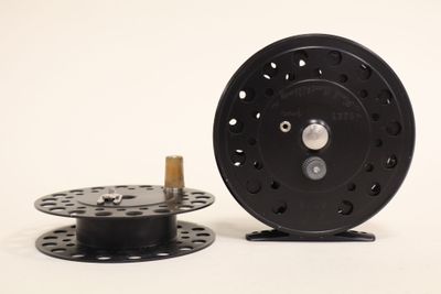 a reel and a spool on a white surface