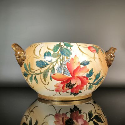 a vase that has flowers painted on it on a table