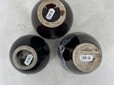three wine bottles that are sitting on a table