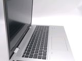 a silver laptop with a black keyboard on a white surface