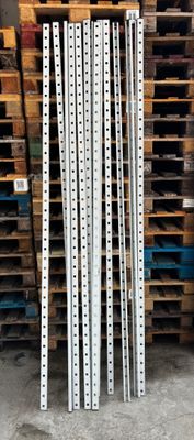 a stack of wooden pallets in a warehouse next to a pallet rack