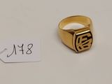 gros plan d'une bague en or sur une surface blanche