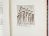 an open book with a picture of a building in it