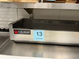 a stainless steel counter top with a sign on it