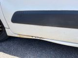 a close up of a white car with a flat tire