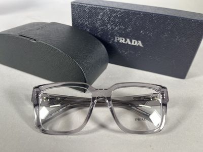 glasses are sitting on a table next to a box of glasses