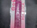 the pink vibrating toy is in the package on the table