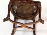 an image of a wooden chair with a cane back and a wicker seat