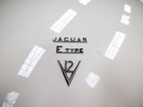 a close up of a clock with a v logo on it