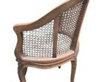 an image of a wooden chair with a woven back and arms