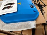 a blue box with a piece of paper on top of it