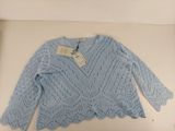 the sweater is blue and has a white tag on it