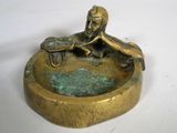 bronze figurine of a man sitting on a bench with a dog