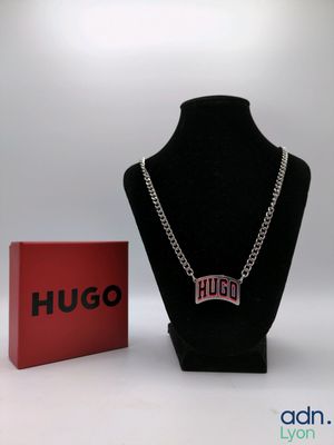 the necklace is next to a red box and a black necklace