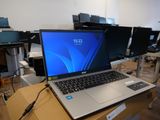 a laptop computer sitting on top of a wooden table