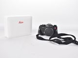 an image of a camera and a box on a white surface