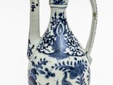 a blue and white vase with a bird design on it