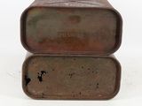 an old metal box with a lid sitting on top of a white surface