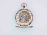 a silver pocket watch that is on a white surface