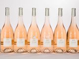 six bottles of wine are lined up in a row