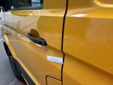 a yellow van parked on the side of the street