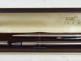 an image of a pen and a ballpoint pen sitting in a box