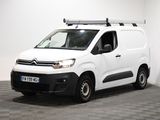 une camionnette Citroën garée dans une pièce au sol carrelé