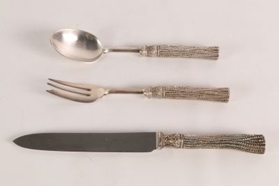 three forks, a spoon, and a knife on a table