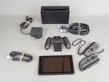 a nintendo wii game system and accessories laid out on a table