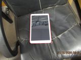 a cell phone sitting on top of a black leather chair