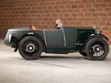 a vintage car parked in front of a brick wall