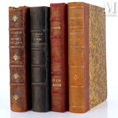 several old books are stacked on top of each other on a white surface