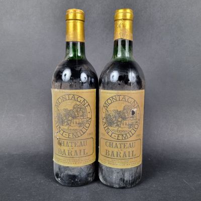 two bottles of wine sitting next to each other on a table